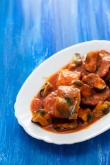 fish with seafood and sweet potato on white dish