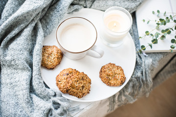 Cozy weekend breakfast with cup of coffee and cookies on ceramic tray