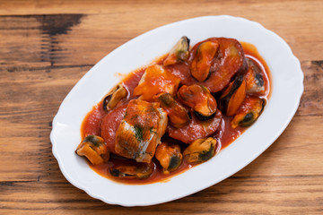 fish with seafood and sweet potato on white dish