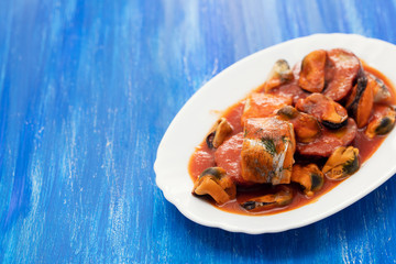 fish with seafood and sweet potato on white dish