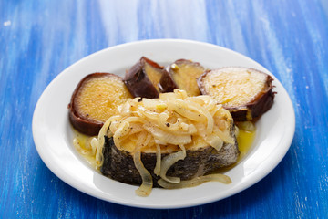 boiled fish with onion and sweet potato on white dish