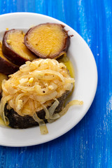 boiled fish with onion and sweet potato on white dish