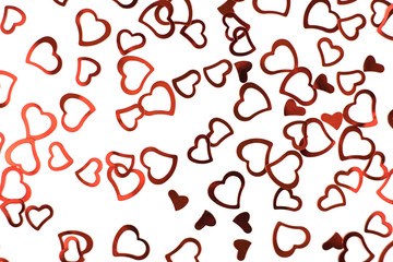 Sparkle red confetti hearts on white background.