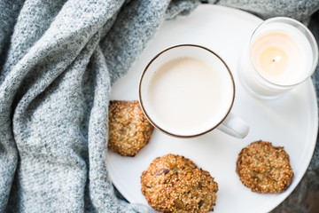 Cozy weekend breakfast with cup of coffee and cookies on ceramic tray
