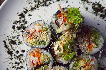 Korean sushi rolls (kimbap or gimbap) cut served on a plate. Top view, closeup view and selective focus. Korean, asian cuisine. Restaurant, food menu, recipe, cafe concept. Lifestyle food