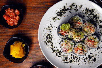 Korean sushi rolls (kimbap or gimbap) cut served on a plate. Top view, closeup view and selective focus. Korean, asian cuisine. Restaurant, food menu, recipe, cafe concept. Lifestyle food