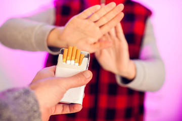 Quitting smoking concept. Hand is refusing cigarette offer. People, stop smoking and healtcare...