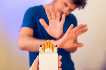 Quitting smoking concept. Hand is refusing cigarette offer. People, stop smoking and healtcare...