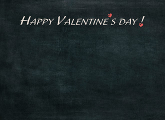 Fototapeta premium Happy Valentine's day written chalk on a blackboard
