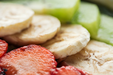 selective focus of sliced organic bananas and strawberries