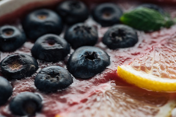 close up of blueberries and sliced lemons in smoothie bowl