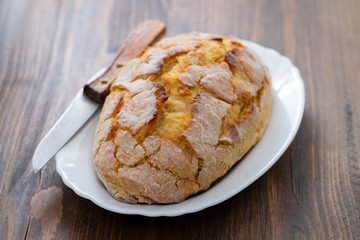 corn bread with knife on white dish