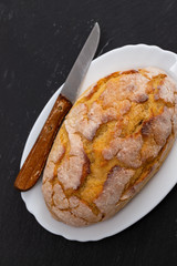 corn bread with knife on white dish
