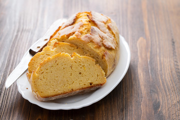 corn bread with knife on white dish