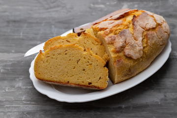 corn bread with knife on white dish