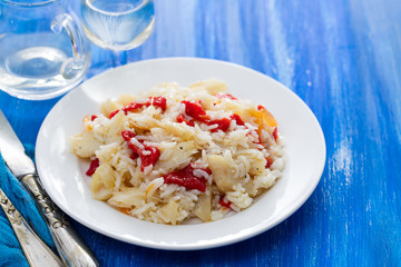 rice with cod fish and red pepper on white dish