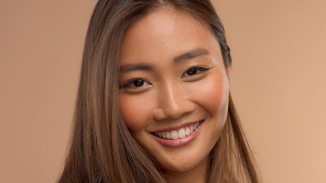 closeup portrait of asian thai japanese model wide smiling to the camera