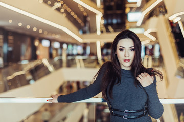 Young brunette girl in modern shopping center. Happiness, positive, fashion concept