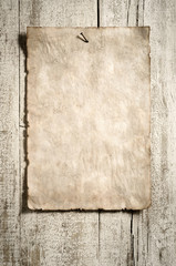 old grunge paper advert on aged wooden wall