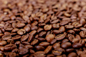 Aroma roasted coffee beans, brown background. Soft focus close up.