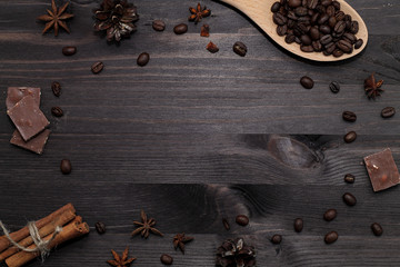 coffee beans and cinnamon sticks on wooden background