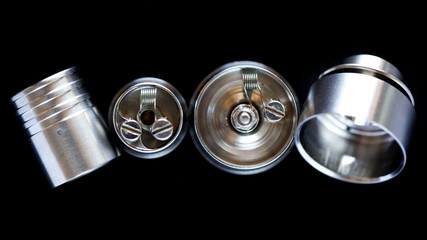 close up, macro shot, top view of single micro coil in high end rebuildable dripping atomizer for flavour chaser isolated on black background, vaping device, selective focus