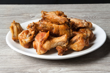 fried chiken wings in the white plate