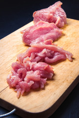 raw meat slices on a cutting board