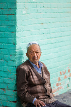 old uigur resting in a corner, china