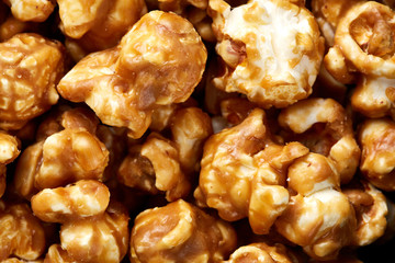 caramel pop corn background. Golden caramel popcorn close up. Background of popcorn. Snacks and food for a movie