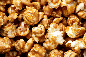 caramel pop corn background. Golden caramel popcorn close up. Background of popcorn. Snacks and food for a movie