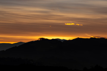 Beautiful romantic sunset in the mountains, black silhouette