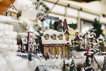 Figures and Christmas decorations in Nordic style, miniature houses with a snowy village.