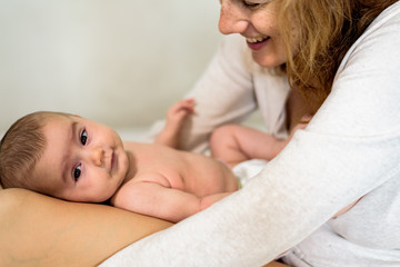 Pretty carefree baby happy with her mommy