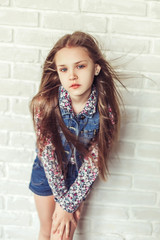 Close up portrait of teen girl model  with long hair posing in studio. Beauty, cheerful, fashionable teenager