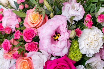 beautiful floral arrangement, pink and yellow rose, pink eustoma, green and pink chrysanthemum, white carnation, pink dahlia on a blue, turquoise background with space for text.