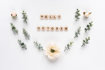 Hello October words on white marble background.