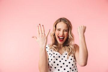 Beautiful excited young blonde woman wearing dress