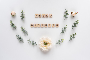 Hello December words on white marble background.