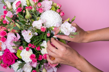 Female florist making beautiful bouquet at flower shop.