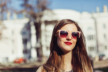 Outdoors fashionable close up portrait of young caucasian model girl