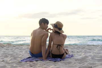 Lover Young Asian happy couple relax on the beach, Couple in love honeymoon vacation and travels concept.Romantic lifestyle. Thailand. Summer,Travel, Valentine Concept.