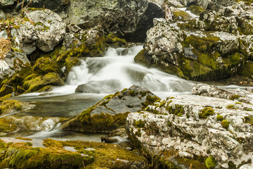 Naklejka na ściany i meble Waterfall in rocks. Fast mountain river