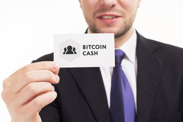 Business, technology, internet and networking concept. Young entrepreneur showing keyword: bitcoin cash