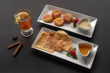 Cheesecakes on a rectangular white plate with tea