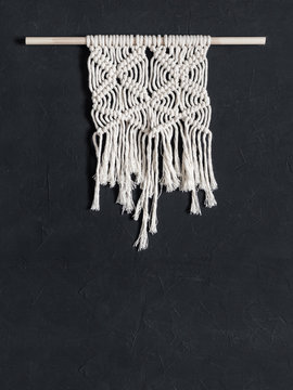 Macrame. Macrame weaving. White thread, black background, closeup