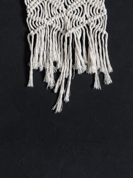 Macrame. Macrame weaving. White thread, black background, closeup