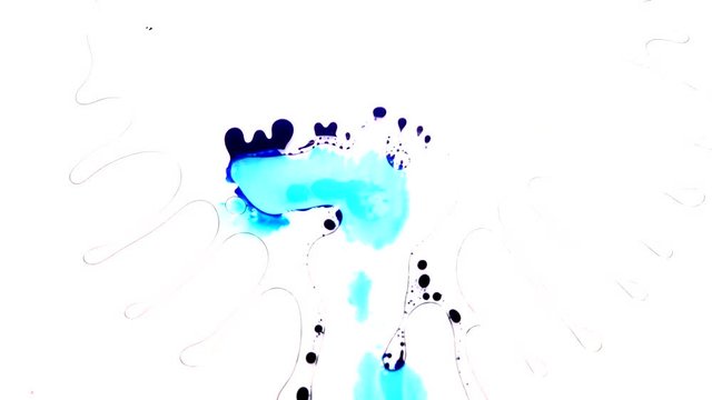 Ink is squashed in between 2 sheets of glass and spreads out creating colourful effects