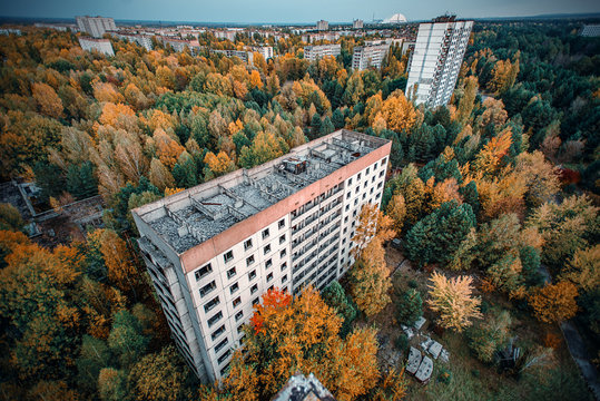 view of the autumn thrown city from the roof of high-rise buildings in the abandoned city