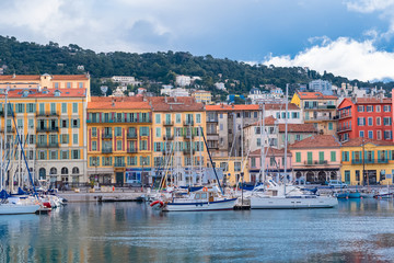 Nice, the harbor, ancient colorful buildings and boats in the marina